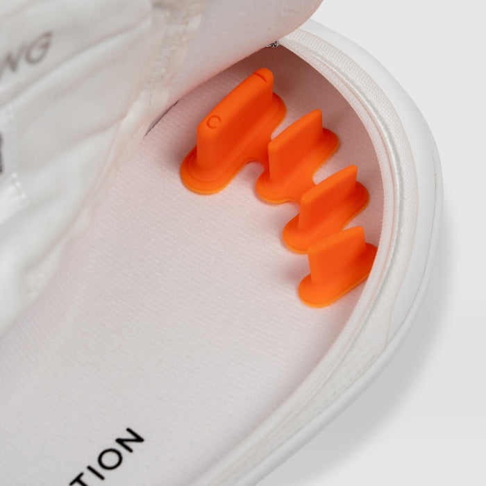 FeetFormers toe spacers attached to the insole of a white Arc trainer