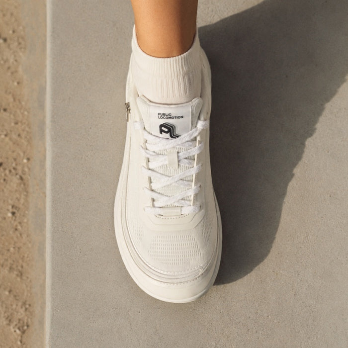 Top-Down view of someone wearing a white Arc trainer.